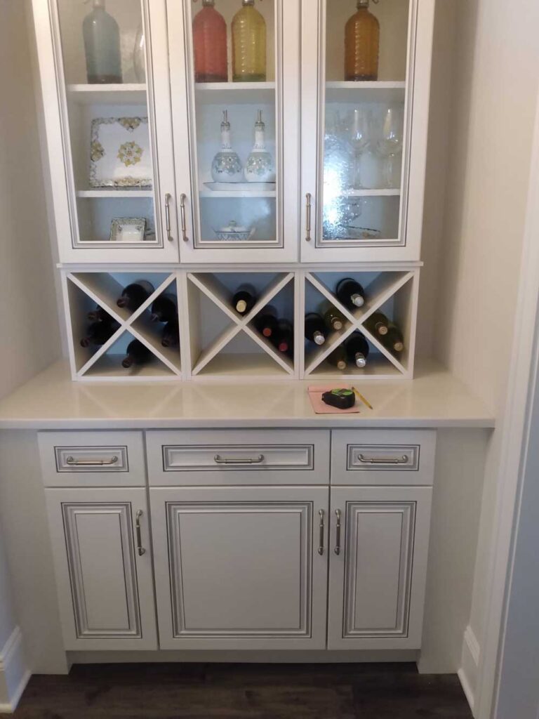 Wine area with white cabinets and quartz countertops.