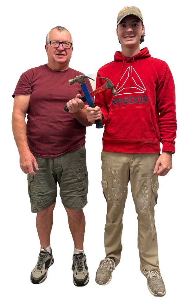 Richard and Nathan Abbott holding hammers so they cross.